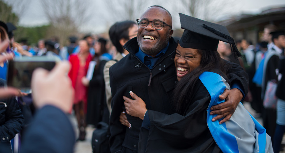 A graduate embraces her father at winter graduation 2019